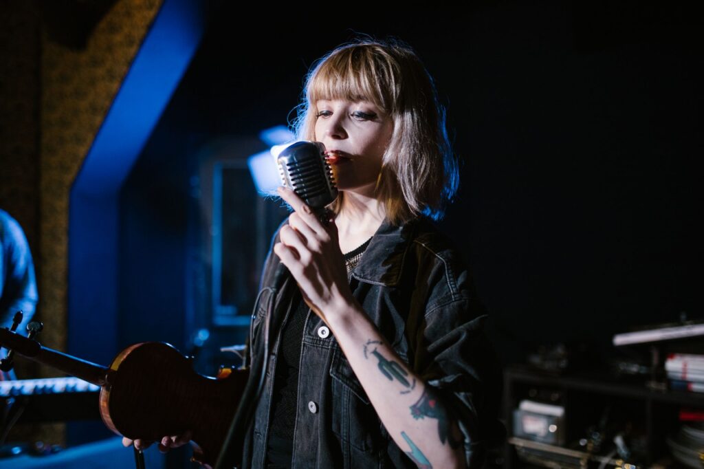 Músico contemporáneo en estudio con equipo vintage, simbolizando la influencia de los 80s y 90s en el indie actual.